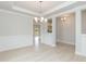 Open concept dining room features hardwood floors and modern chandelier; entrance to stairs at 283 Hopewell Br Ct, Smithfield, NC 27577