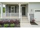 Charming front entrance featuring stone accents, white railings, and lush landscaping at 283 Hopewell Br Ct, Smithfield, NC 27577