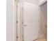 Hallway with doors, leading to other rooms, featuring white trim and neutral walls at 283 Hopewell Br Ct, Smithfield, NC 27577