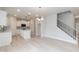 Open-concept kitchen with an island, white cabinetry, stainless appliances, and an adjacent living room at 283 Hopewell Br Ct, Smithfield, NC 27577