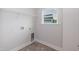 Functional laundry room with shelving, hookups, and a window for natural light at 283 Hopewell Br Ct, Smithfield, NC 27577