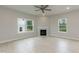 Bright living room with hardwood floors, a fireplace, large windows, and a ceiling fan at 283 Hopewell Br Ct, Smithfield, NC 27577