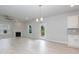 Open living room with hardwood floors, a fireplace, ceiling fan, and access to outdoor deck at 283 Hopewell Br Ct, Smithfield, NC 27577