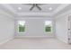 Large main bedroom with a ceiling fan and two large windows at 283 Hopewell Br Ct, Smithfield, NC 27577
