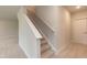 Carpeted stairway with a wooden handrail, offering a seamless transition between floors at 283 Hopewell Br Ct, Smithfield, NC 27577