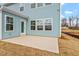 Outdoor patio with blue siding, glass doors, and a well maintained lawn at 3008 Dog Rose Dr # 307, Durham, NC 27703