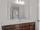 Bathroom features a bright mirror and white quartz countertop, with brown cabinets at 3008 Dog Rose Dr # 307, Durham, NC 27703