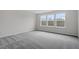 Bedroom with gray carpet, neutral walls, and a large window at 3008 Dog Rose Dr # 307, Durham, NC 27703
