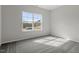Bedroom featuring neutral walls, carpeted floors, and a large window offering abundant natural light at 3008 Dog Rose Dr # 307, Durham, NC 27703