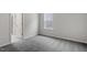 Bedroom with gray carpet, neutral walls, window, and white door at 3008 Dog Rose Dr # 307, Durham, NC 27703
