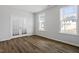 A bedroom showcasing wood floors, neutral walls, natural light, and a glass paneled door at 3008 Dog Rose Dr # 307, Durham, NC 27703