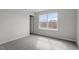 Bedroom with gray carpet, neutral walls, window, and white door at 3008 Dog Rose Dr # 307, Durham, NC 27703