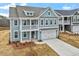 Charming two-story home with a balcony, blue siding, and a two-car garage at 3008 Dog Rose Dr # 307, Durham, NC 27703