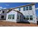Side view of a new two-story home with a walk-up side entrance under construction with blue sky at 3008 Dog Rose Dr # 307, Durham, NC 27703