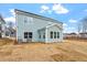 Exterior backyard view of home showing light-blue siding, multiple windows and spacious yard at 3008 Dog Rose Dr # 307, Durham, NC 27703