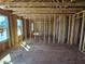 Interior framing of a new home featuring stud walls, flooring, and natural light at 3008 Dog Rose Dr # 307, Durham, NC 27703