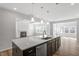 Bright kitchen with quartz counters, stainless appliances and decorative pendant lights at 3008 Dog Rose Dr # 307, Durham, NC 27703