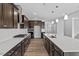 Kitchen featuring granite counters, stainless appliances, dark wood cabinets and island sink at 3008 Dog Rose Dr # 307, Durham, NC 27703