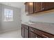 Laundry room features granite countertops, wooden cabinets and a practical utility sink at 3008 Dog Rose Dr # 307, Durham, NC 27703