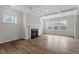Living room with fireplace, ample windows and wood-look flooring at 3008 Dog Rose Dr # 307, Durham, NC 27703