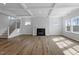 Bright living room featuring a fireplace, coffered ceilings, and hardwood floors at 3008 Dog Rose Dr # 307, Durham, NC 27703