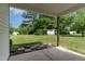Patio space with view of grassy backyard and shed at 303 Godwin St, Selma, NC 27576