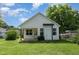 White house featuring green lawn and well-maintained landscaping in backyard at 303 Godwin St, Selma, NC 27576