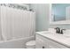 Bathroom with a vanity, toilet, and a tub/shower combination with white shower curtain at 303 Godwin St, Selma, NC 27576