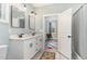 Modern bathroom featuring double vanity, updated fixtures, and doorway to bedroom at 303 Godwin St, Selma, NC 27576
