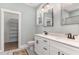 Bathroom featuring double vanity, elegant mirrors, and a walk-in closet at 303 Godwin St, Selma, NC 27576