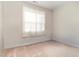 Bright bedroom featuring natural light and neutral carpet at 303 Godwin St, Selma, NC 27576