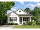 Charming home featuring a gray door, black shutters, and lush lawn with a traditional design at 303 Godwin St, Selma, NC 27576