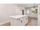 Modern kitchen island featuring white cabinets and drawers, with the dining area adjacent at 303 Godwin St, Selma, NC 27576