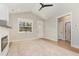 Spacious living room featuring wood floors and fireplace next to a large window at 303 Godwin St, Selma, NC 27576