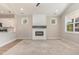 Bright open-concept living room featuring modern fireplace and adjacent to kitchen at 303 Godwin St, Selma, NC 27576
