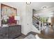 Stylish entryway featuring modern art, decorative furniture, and a staircase at 327 Augusta Pond Way # 172, Raleigh, NC 27603