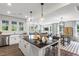 Open kitchen concept showcasing a large island, stainless appliances and seamless flow to living area at 327 Augusta Pond Way # 172, Raleigh, NC 27603