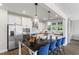 Modern kitchen featuring stainless steel appliances, white cabinetry, and sleek black countertops at 327 Augusta Pond Way # 172, Raleigh, NC 27603