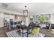Bright open-concept living area featuring modern decor, stainless steel appliances, and lots of natural light at 327 Augusta Pond Way # 172, Raleigh, NC 27603
