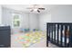 bedroom with an area rug, a ceiling fan, and neutral walls and carpet at 3413 S Beaver Ln, Raleigh, NC 27604
