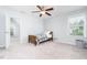 Bedroom featuring neutral carpet, a twin bed, a ceiling fan, and a connected bathroom at 3413 S Beaver Ln, Raleigh, NC 27604