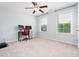 Bright bedroom with two large windows, neutral carpeting, and a ceiling fan at 3413 S Beaver Ln, Raleigh, NC 27604