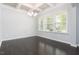 Bright dining room with a modern chandelier, tray ceiling, and large windows for natural light at 3413 S Beaver Ln, Raleigh, NC 27604