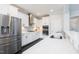 Modern kitchen boasts white cabinetry, stainless steel appliances, and a sleek quartz countertop at 3413 S Beaver Ln, Raleigh, NC 27604