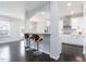 Open-concept kitchen featuring white cabinets, stainless steel appliances, and a convenient breakfast bar at 3413 S Beaver Ln, Raleigh, NC 27604