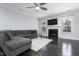 Comfortable living room features a fireplace, large sectional sofa, and ample natural light at 3413 S Beaver Ln, Raleigh, NC 27604