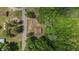 Aerial shot of a home surrounded by lush greenery and a road nearby at 3899 Warrenton Rd, Henderson, NC 27537