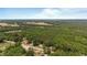 Aerial perspective of rural homes enveloped by verdant woodland at 3899 Warrenton Rd, Henderson, NC 27537
