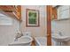 Modest bathroom featuring dual sinks, bathtub, window, and ample storage at 3899 Warrenton Rd, Henderson, NC 27537