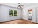 The bedroom includes wood floors, neutral walls, and an adjacent bathroom at 3899 Warrenton Rd, Henderson, NC 27537